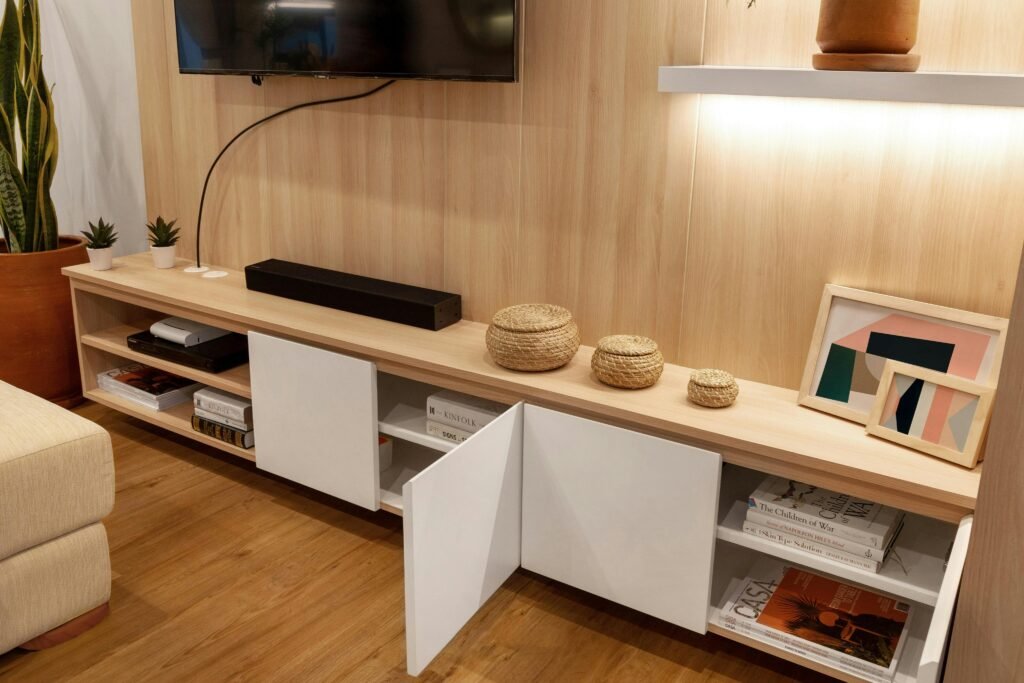 Stylish modern living room featuring wooden decor, shelving, and minimalist design.